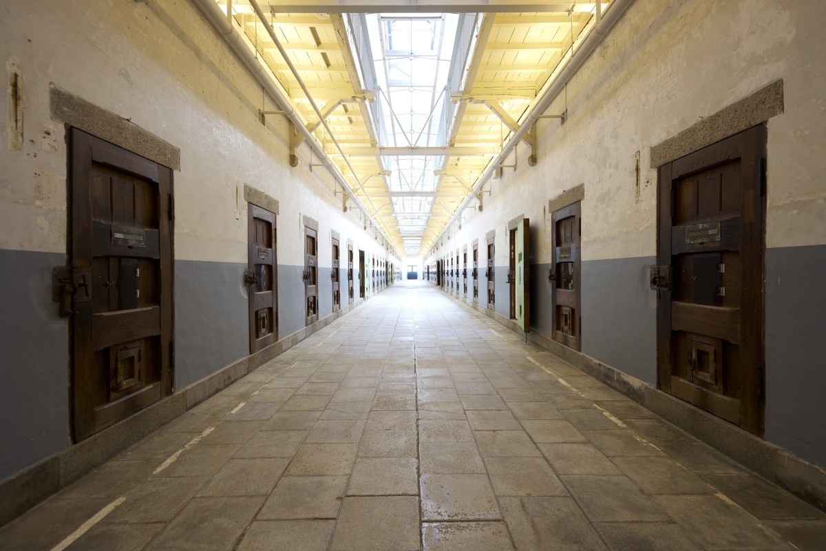 Long cell corridor at Nara Prison Museum lined with original wooden cell doors
