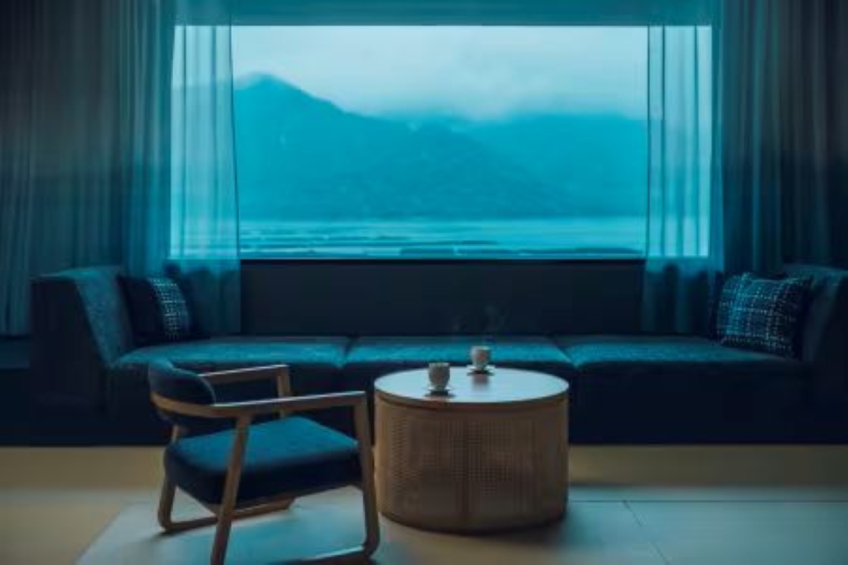 KAI Signature Room interior with gradated blue curtains and sea view at KAI Miyajima
