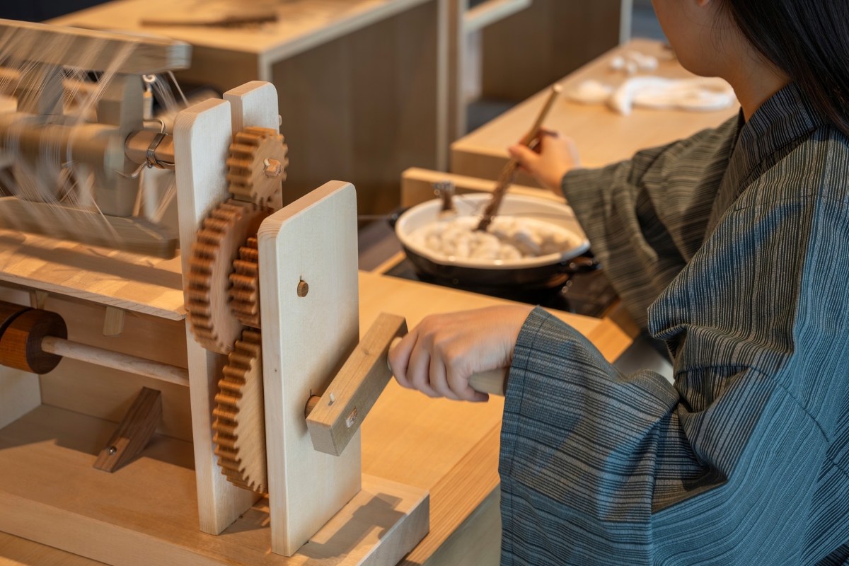 Guest spinning silk using a zaguri hand-reeling machine at KAI Kusatsu