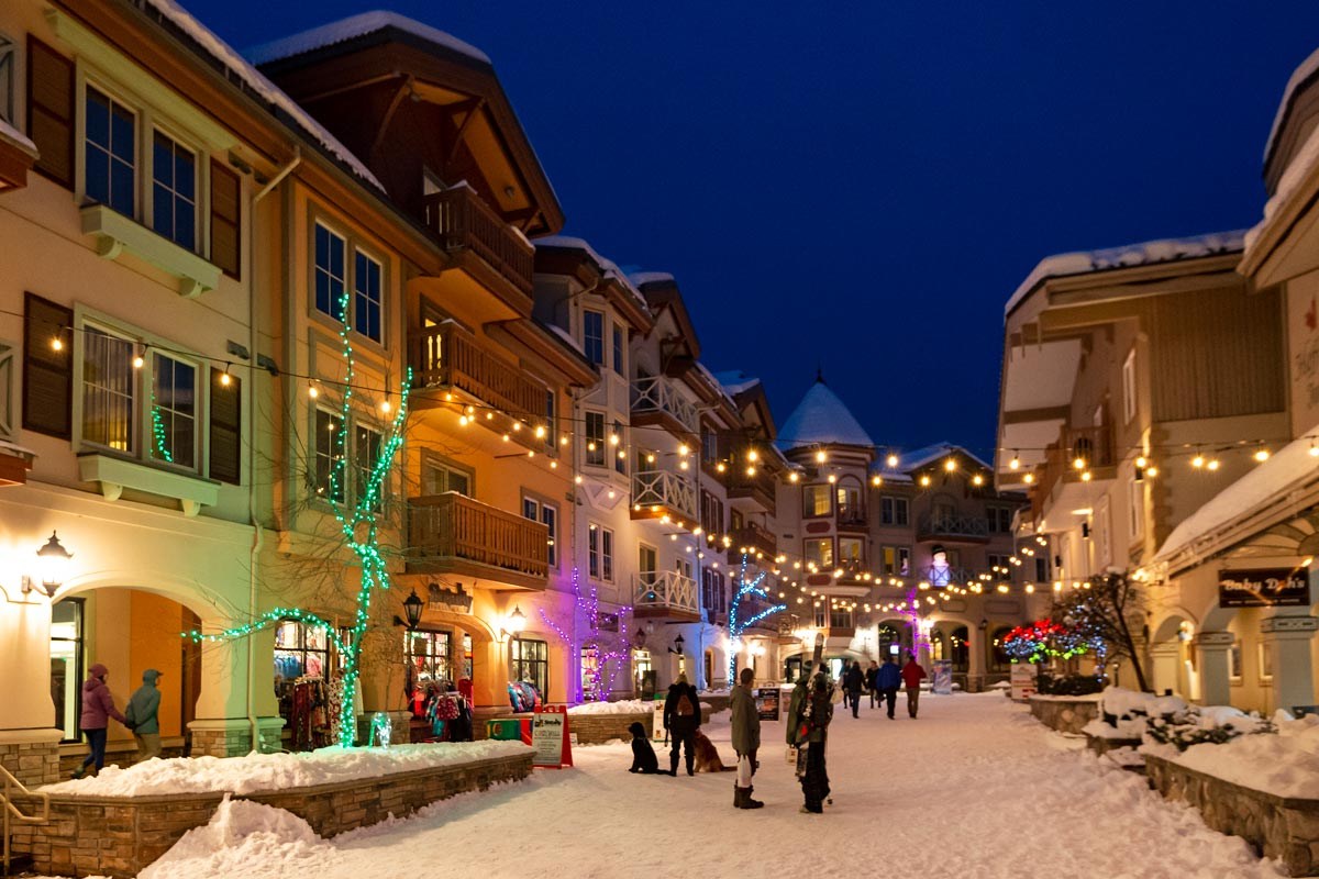 Sun Peaks village lit up with festive lights on a snowy evening, British Columbia