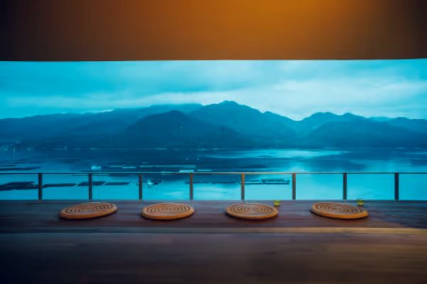 Terrace seating at KAI Miyajima at dusk, overlooking the Seto Inland Sea