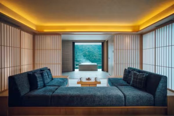 Suite living area with shoji screens and private open-air onsen visible through the doorway