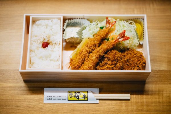 A Japanese bento box of fried prawn and pork cutlet with rice