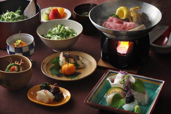 Multi-course Japanese dining spread at HOSHINOYA Nara Prison, including a tabletop wagyu hot pot