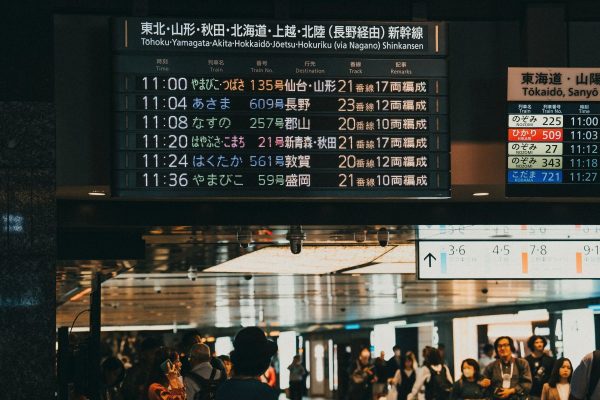 A Shinkansen departure board showing upcoming train times in Japan