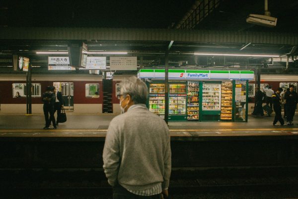 Waiting on a platform beside a station convenience store in Japan