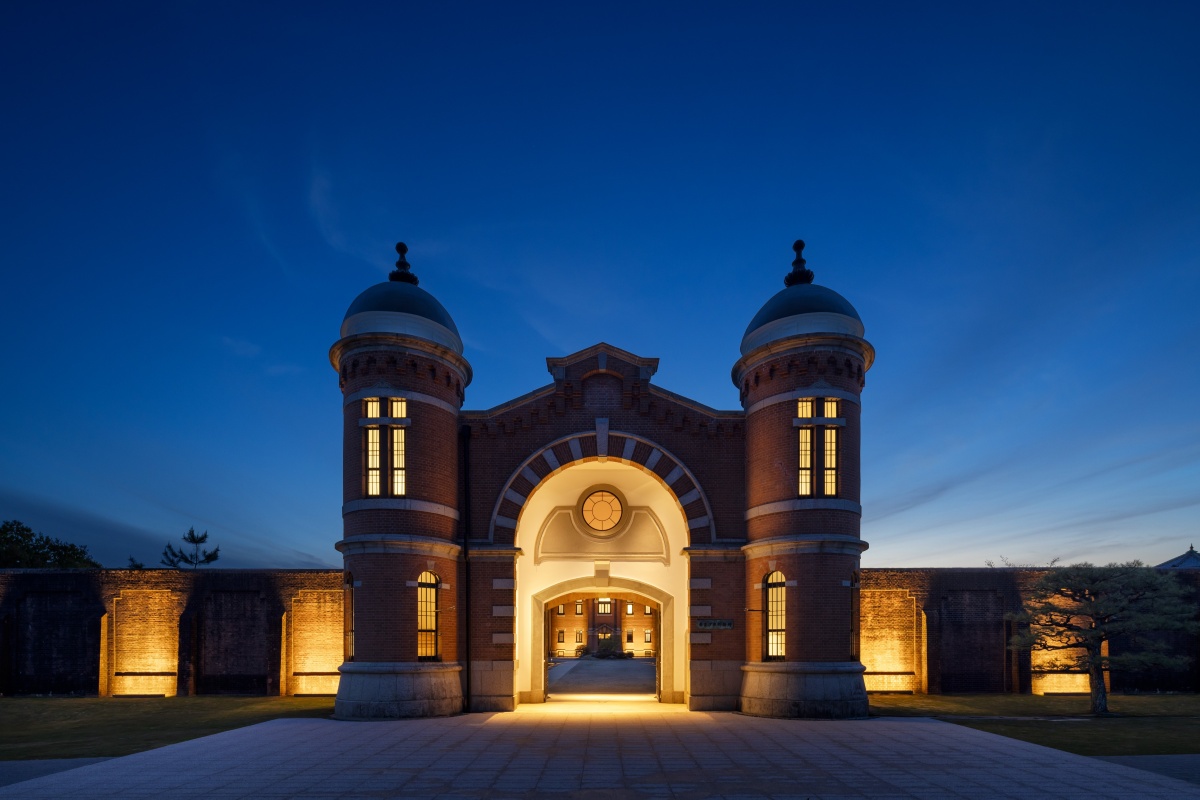 Illuminated front gate of HOSHINOYA Nara Prison at dusk