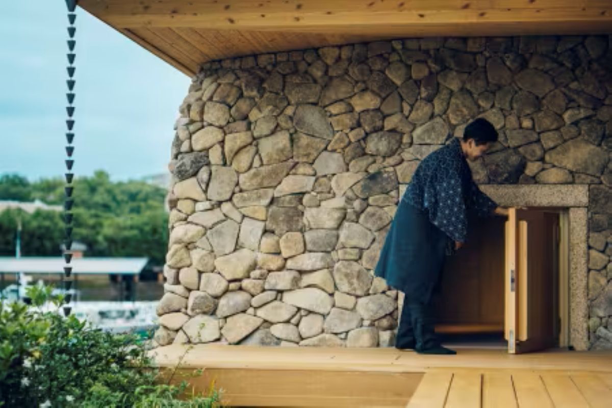 Guest entering the stone Setouchi Ancient Sauna at KAI Miyajima
